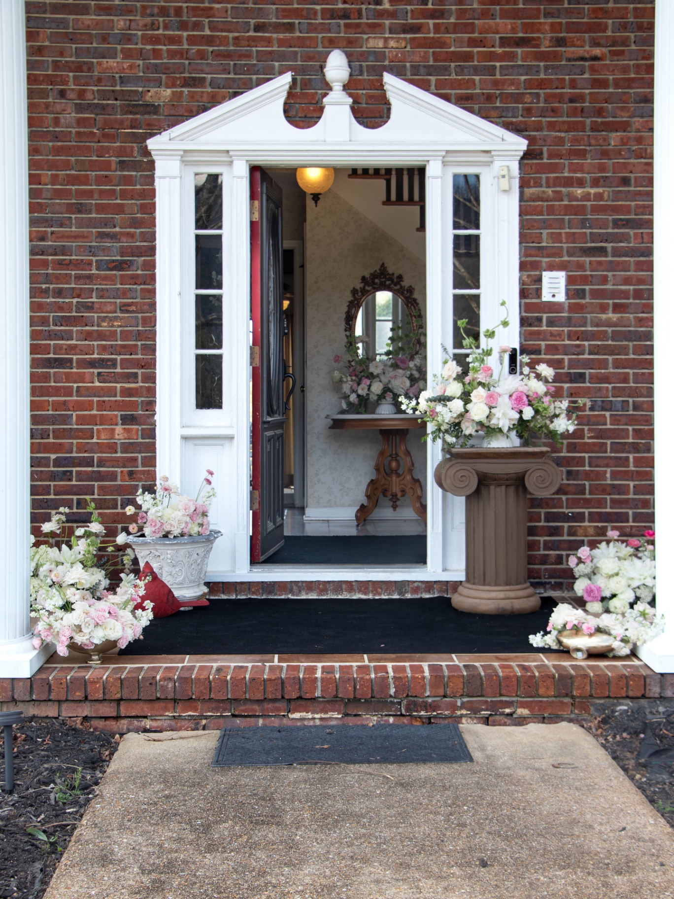 Farmhouse front entry styled with floral arrangements at L & D Farms