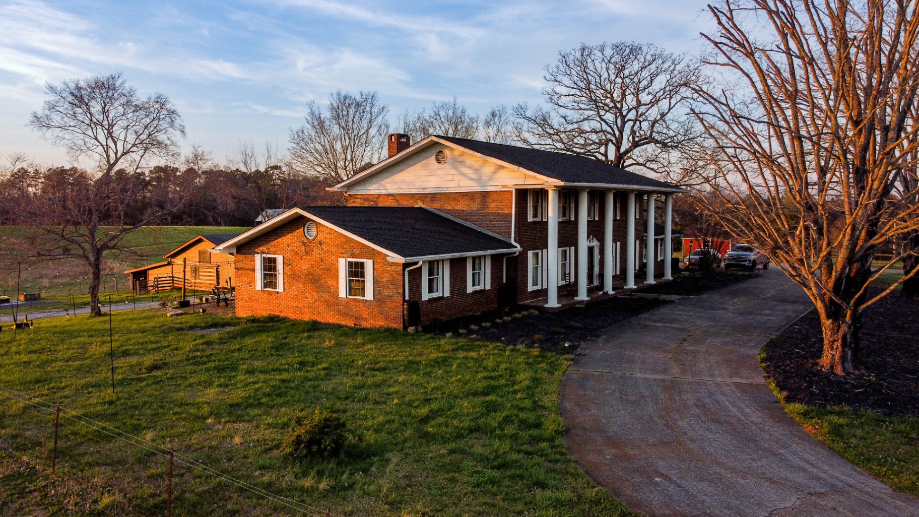 Historic brick farmhouse with columns at L & D Farms