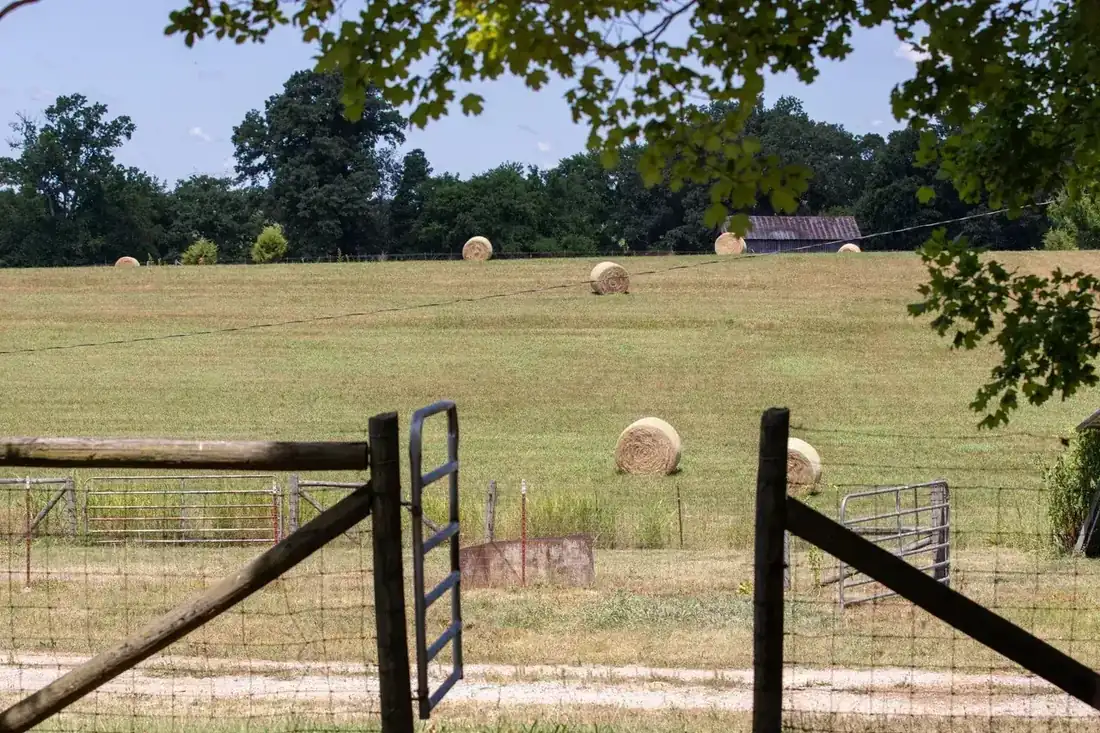 Rolling pasture with hay bales at L & D Farms in Ooltewah, TN
