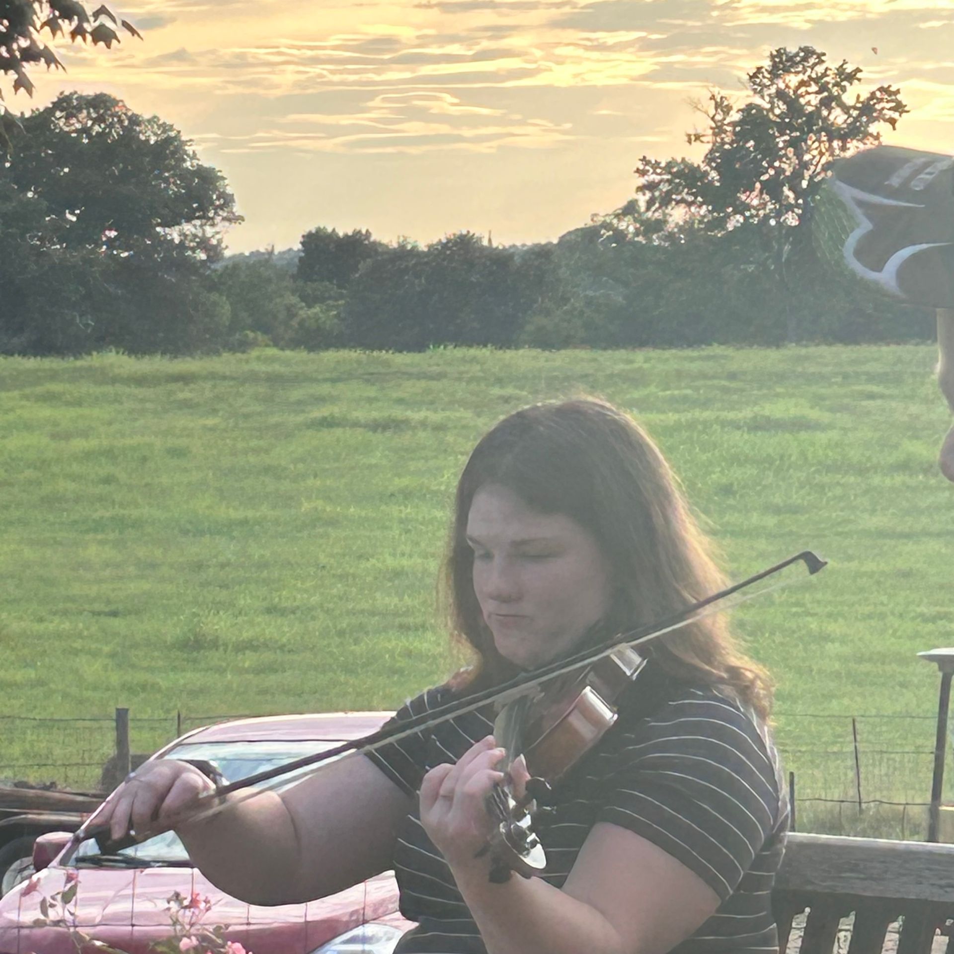 Violin performance at sunset event at L & D Farms